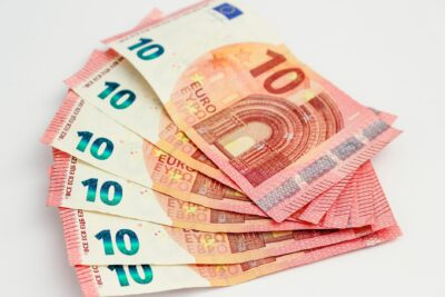 Close-up of a fan of 10 euro banknotes on a clean white background, showcasing European currency. (photo Pexels)